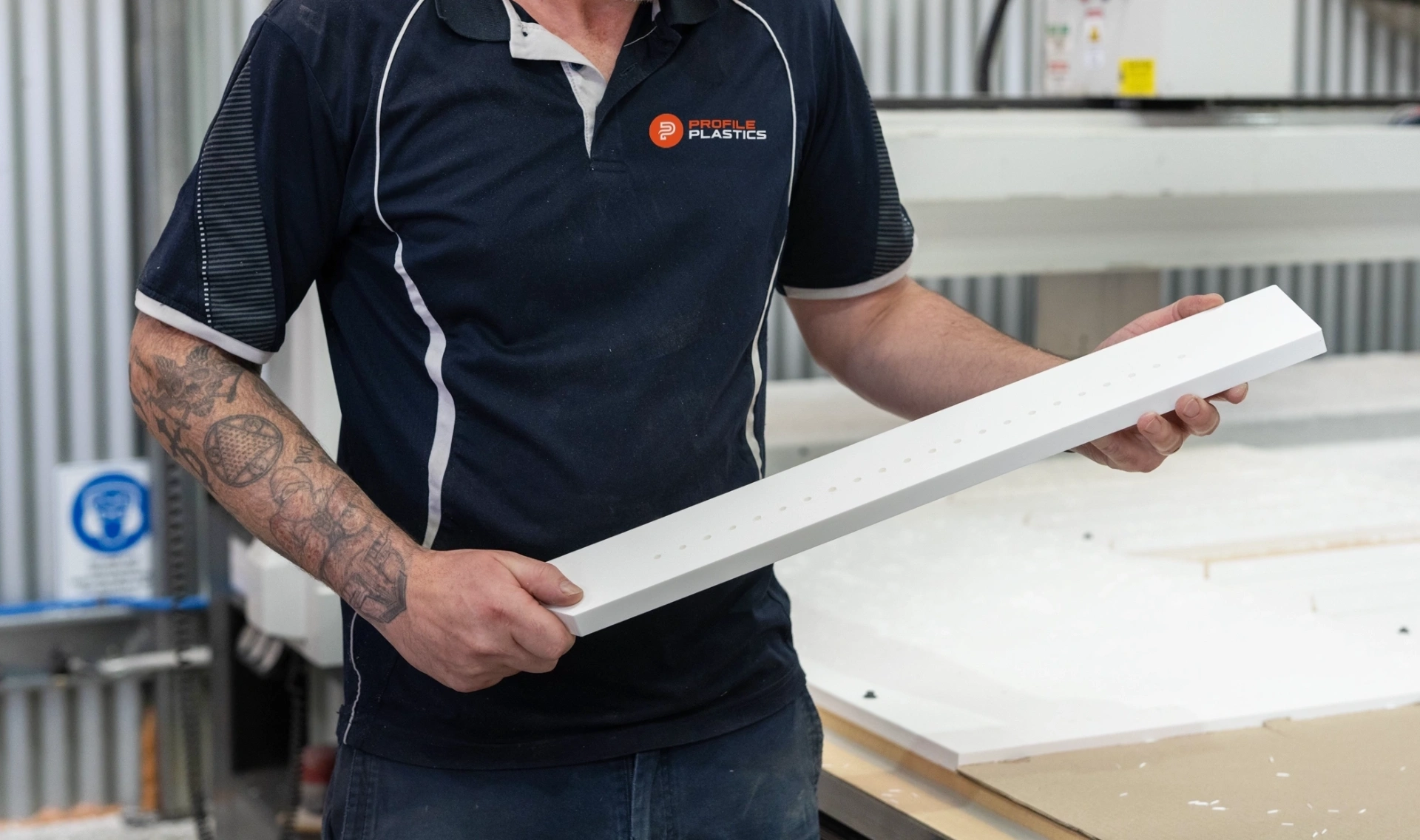 Profile Plastics craftsman holding a precision-machined plastic panel